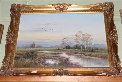 Lot 527 - Wendy Reeves, river landscape with ducks in flight, oil on canvas