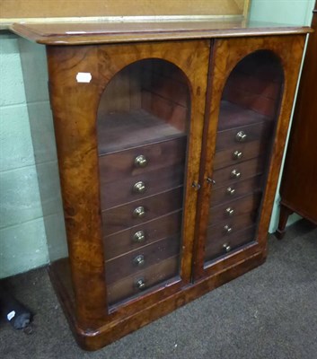 Lot 576 - A Victorian walnut cabinet with arched glazed doors enclosing drawers