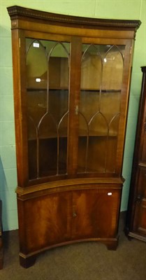 Lot 584 - A Reprodux mahogany standing corner cabinet