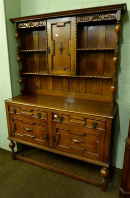 Lot 585 - A 1920's oak dresser and rack