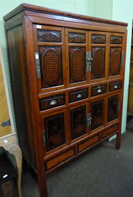 Lot 586 - A 20th century part ebonised Chinese hardwood cabinet fitted with an arrangement of cupboard...