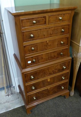 Lot 589 - A reproduction burr walnut chest on chest of small proportions