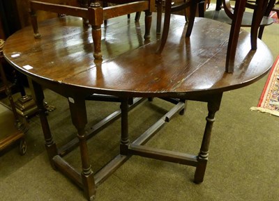 Lot 602 - An oak gateleg dining table