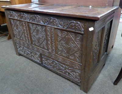 Lot 612 - An 18th century carved oak panelled coffer, fitted with two base drawers and lined as a chest