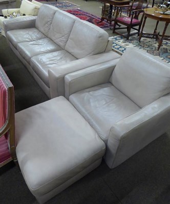 Lot 632 - A modern leather three piece suite comprising three seater sofa, chair and pouffe and a further...