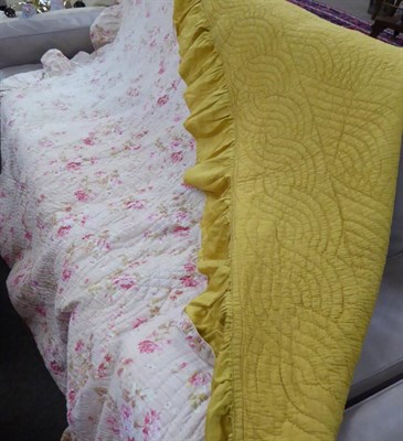 Lot 633 - Pink rose floral quilt with mustard reverse and frilled trim