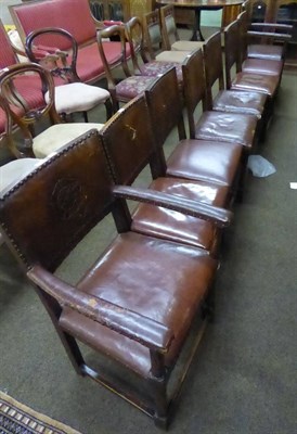 Lot 637 - A set of eight 1920's oak framed studded and tooled leather dining chairs inlcuding two carvers