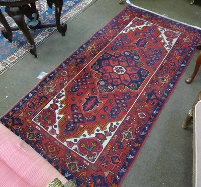 Lot 646 - A Hamadan rug, Iranian Kurdistan, the blood red field centred by an indigo medallion, framed by...