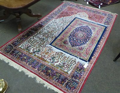 Lot 650 - A machine made rug of Islamic prayer design, 230cm by 150cm; together with another rug (2)