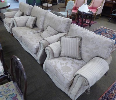 Lot 661 - A modern three piece suite comprising a two seater sofa and two chairs together with a matching...