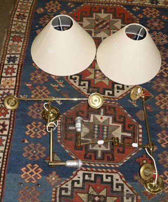 Lot 665 - A pair of brass wall lights with shades