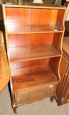 Lot 677 - An Edwardian inlaid mahogany waterfall bookcase, fitted with a base cupboard and moving on castors