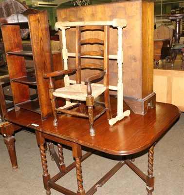 Lot 684 - A 1920's oak gateleg dining table, an open bookcase of similar date, a child's Lancashire style...