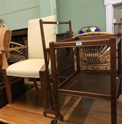 Lot 688 - An oak two tier trolley, a wicker linen basket and a towel rail