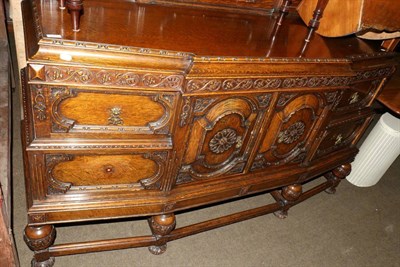 Lot 691 - An ornately carved oak sideboard