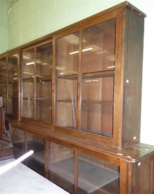 Lot 708 - Large oak bookcase with sliding doors