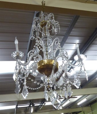 Lot 724 - A large glass six branch chandelier with faceted drops