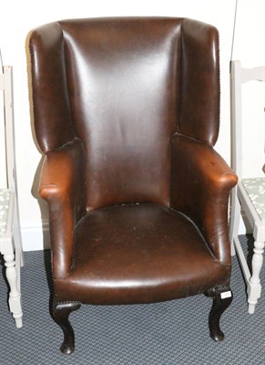 Lot 729 - A George III style leather wing chair