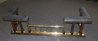 Lot 731 - An oak and brass club fender, with leather upholstered seats on turned column supports