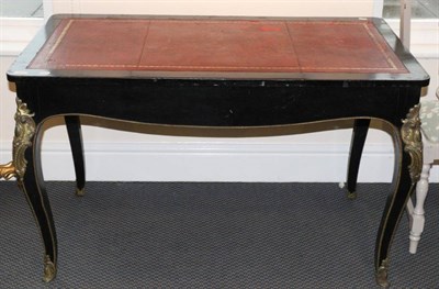 Lot 740 - An ebonised French leather inset bureau plat