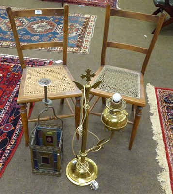 Lot 749 - A pair of cane seated chairs, a coloured glass and brass lantern and a brass lamp