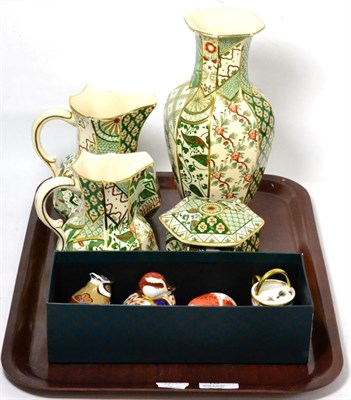 Lot 10 - A group of three Royal Crown Derby Imari paperweights and a miniature watering can together...
