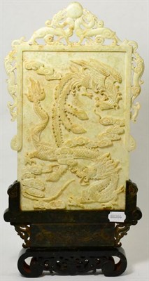 Lot 40 - A Chinese carved stone table screen decorated in relief with a dragon and a phoenix, calligraphy to