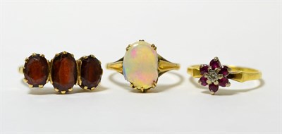 Lot 55 - A 9ct gold garnet ring, an 18ct gold ruby and diamond cluster ring and an opal ring (a.f.)