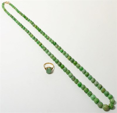 Lot 65 - A jade necklace and a 9ct gold jade ring (2)