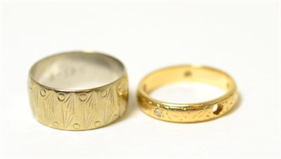 Lot 83 - A 9ct gold band ring and a diamond eternity ring (one diamond deficient)