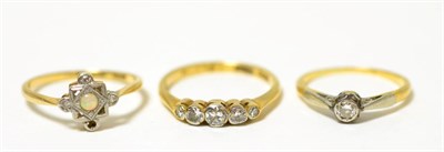 Lot 84 - A five stone diamond ring, a solitaire diamond ring and an opal and diamond ring (one diamond...