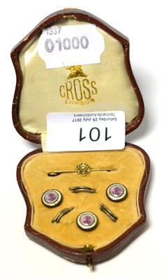 Lot 101 - A seed pearl set tie pin and cased enamel dress studs