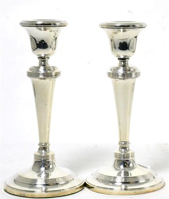 Lot 105 - A pair of Georgian style silver candlesticks, Birmingham, 1912