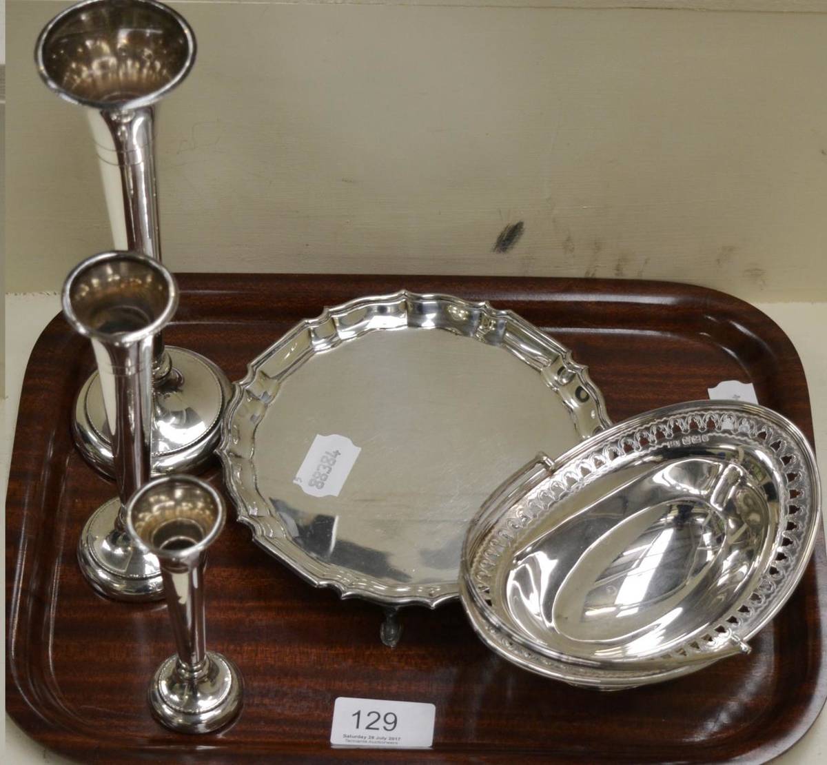 Lot 129 - A silver waiter, bowl and three bud vases