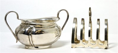 Lot 137 - A silver twin handled sugar bowl and toast rack