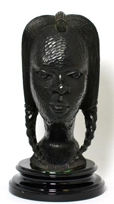 Lot 146 - An African carved ebony female head, on black socle plinth base
