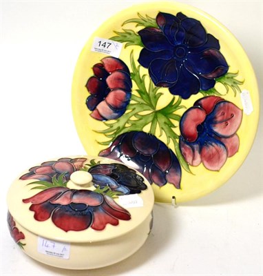 Lot 147 - A Walter Moorcroft ";Anemone"; bowl and cover on a cream ground together with a similar plate (2)