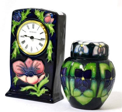Lot 164 - A Moorcroft anemone pattern clock and Violet pattern ginger jar and cover (2)