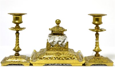 Lot 181 - A gilt brass desk set, inkwell with a pair of candlesticks (3)