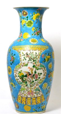 Lot 206 - A Chinese porcelain baluster vase decorated with a vase to either side on a blue ground with flower