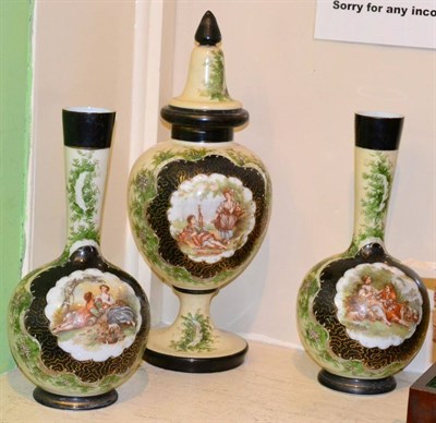 Lot 240 - A set of three Victorian painted glass vases decorated with vignettes of courting couples