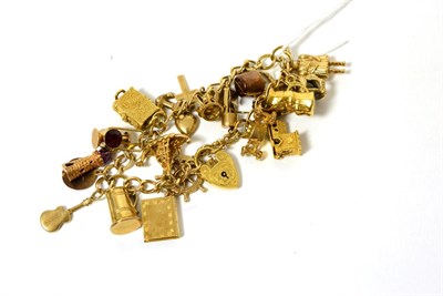 Lot 271 - A 9ct gold charm bracelet with approximately twenty charms, mostly hallmarked 9ct