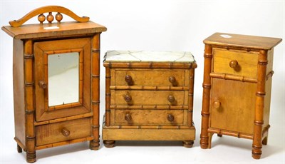 Lot 318 - A three piece miniature bedroom suite in the aesthetic taste comprising wardrobe, tallboy,...