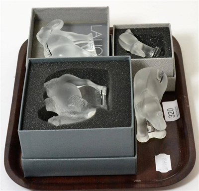 Lot 320 - Four Lalique glass models comprising a camel (boxed), two elephants (one boxed) and a circus...