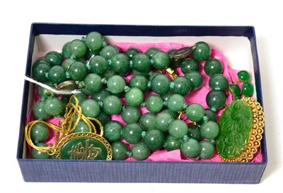 Lot 356 - A carved jade brooch in a frame stamped '585', a pair of jade set screw back earrings, stamped...