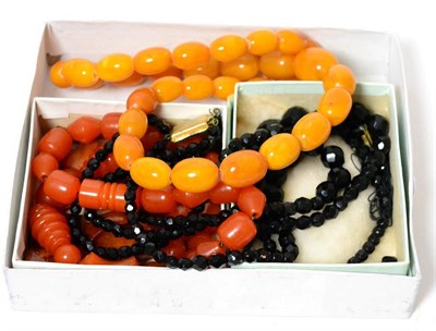 Lot 357 - An amber bead necklace, a French black jet necklace and an orange coloured bead necklace (3)