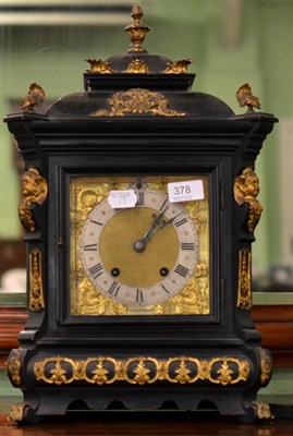 Lot 378 - An ebonised striking table clock with applied gilt metal mount