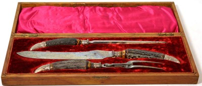 Lot 406 - A cased three piece silver collared antler handled carving set