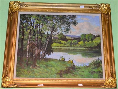 Lot 1013 - Arthur Bateman (20th century), trees by a lake, oil on canvas, (relined), signed and dated...