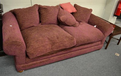 Lot 1179 - A feather filled four seater sofa